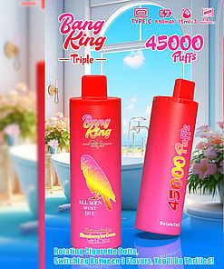 A Promotional Image Featuring Two Vaping Devices Labeled 'Bang King Triple,' With Colorful Branding And Details Such As '45000 Puffs,' Set Against A Bright And Aesthetic Indoor Bathroom Background With Pink Flowers And A Large Window.