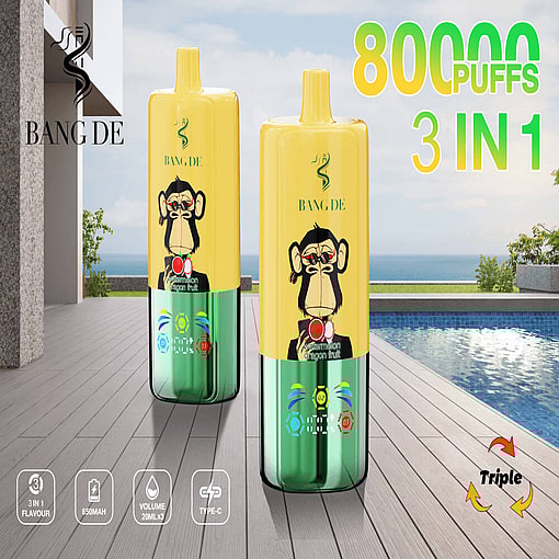 Two Bang De Vape Pens Are Displayed On A Wooden Deck By A Pool, Featuring A Yellow And Green Design With A Monkey Graphic, Highlighting 80,000 Puffs And Multiple Flavors.
